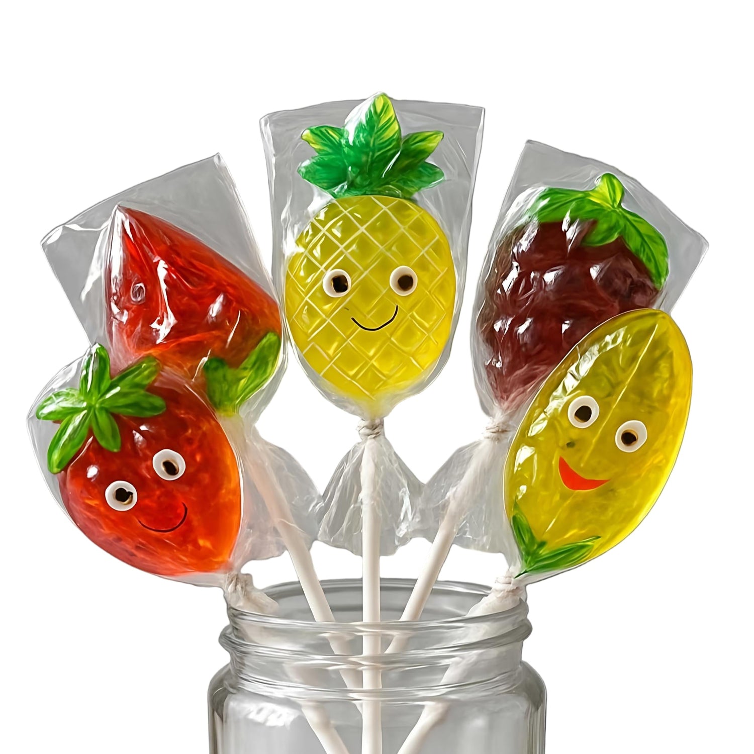 Fruit-shaped lollipops in a clear jar on a white background